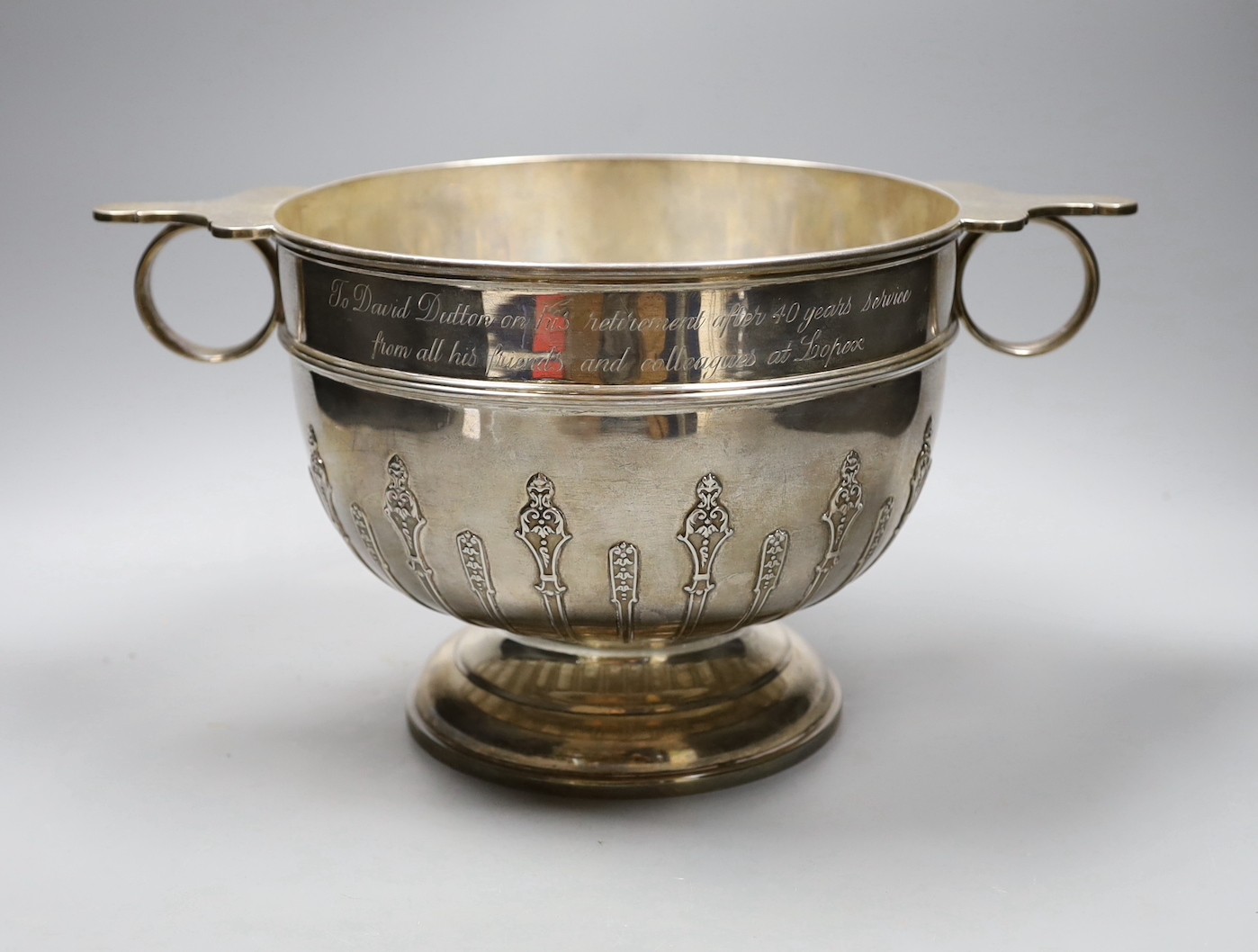 A late Victorian two handled silver rose bowl, with strapwork decoration and later presentation inscription, London 1900, 1532 grams, 35cm over handles, height 18cm